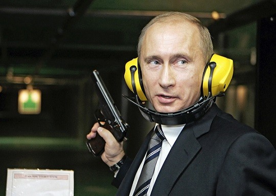 Russian President Putin stands with a gun at a shooting gallery in Moscow